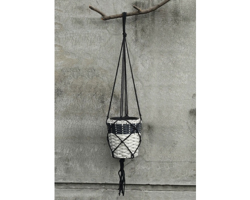 Hängeampel mit geflochtenem Blumenübertopf an einem Ast