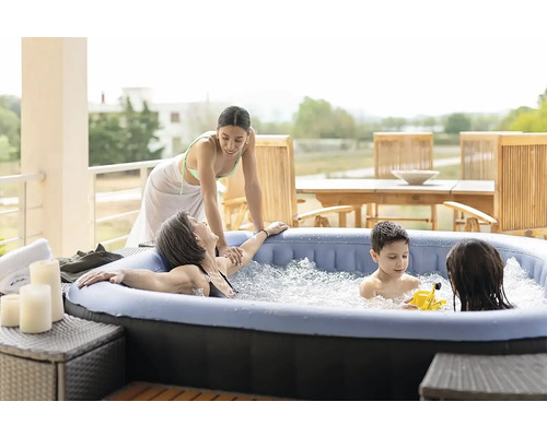 Familie entspannt im aufblasbaren Whirlpool auf der Terrasse