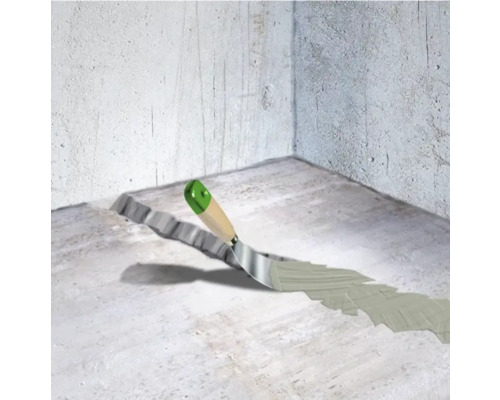 Reparatur von Rissen im Betonboden mit einer Spachtel