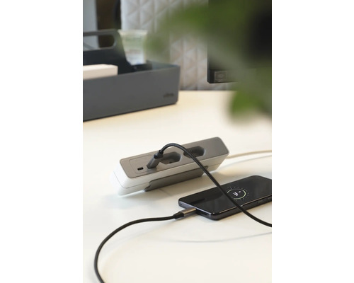 Mehrfachsteckdose mit USB-Anschluss lädt Mobiltelefon