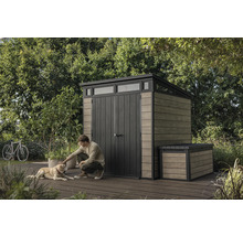 Gartenszene mit Gerätehaus und Truhe, Mann streichelt Hund