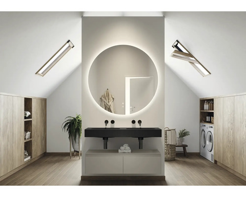 Helles Badezimmer im Dachgeschoss mit rundem Spiegel mit Beleuchtung, Waschbecken, Dachfenstern und Einbauschränken