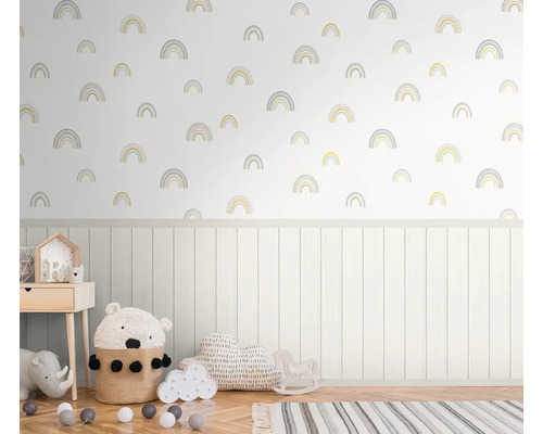 Kinderzimmer mit Regenbogen Tapetenmuster, Holzvertäfelung und diversen Dekoartikeln.