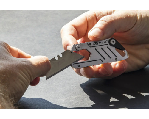 Eine Person schiebt eine Klinge in ein kleines Universalmesser.