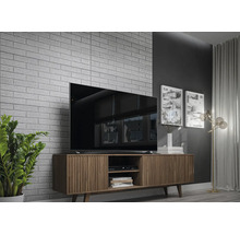 Wohnzimmer mit Fernseher, TV-Schrank und dekorativer Ziegelwand.