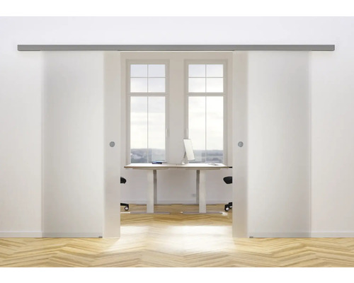 Zwei Glasschiebetüren mit Metallschiene öffnen sich zu einem Arbeitszimmer mit Schreibtisch.