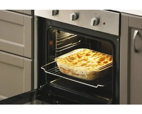 Offener Backofen mit Auflaufform auf einem Gitterrost.