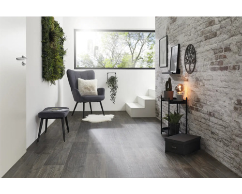 Modernes Wohnzimmer mit Sessel, Hocker und dekorativen Elementen