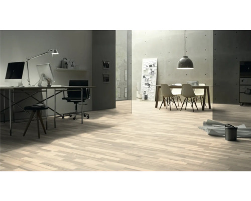 Heller Raum mit Holzboden, Schreibtisch und Esstisch.