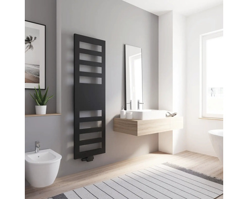 Badezimmer mit schwarzem Heizkörper, Waschbecken, Spiegel und Bidet in hellem Raum