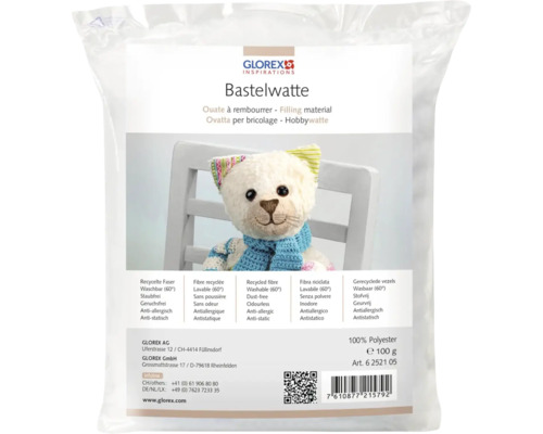 Bastelwatte in einer Verpackung mit einem Teddybär im Vordergrund