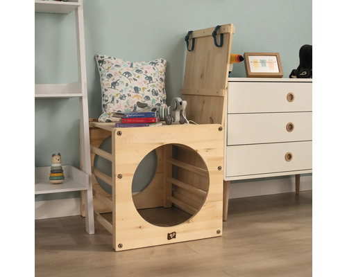 Holzspielkiste mit Kissen, Spielzeug und Büchern in einem Kinderzimmer