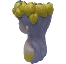 Blumentopf in Form einer Frau mit Zitronen auf dem Kopf