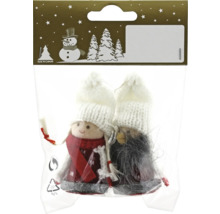 Zwei dekorative Figuren in einer Verpackung mit weißen Mützen und Filzkleidung als Weihnachtsdekoration.