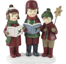 Dekorative Weihnachtsfigurengruppe mit drei singenden Kindern mit Notenbuch und Sternenstab auf einer Schneebasis