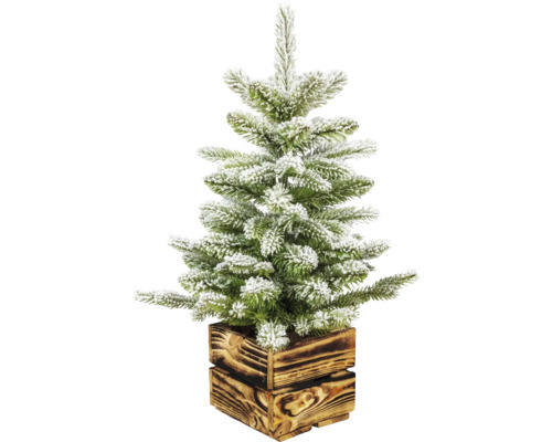 Verschneiter künstlicher Weihnachtsbaum in Holzkiste