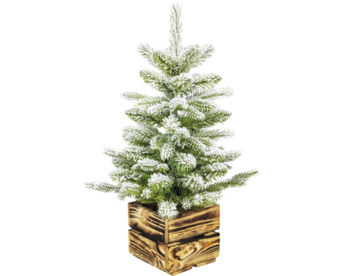 Künstlicher, beschneiter Weihnachtsbaum im Holztopf