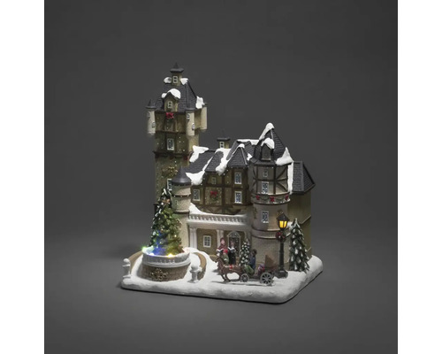Dekorative Weihnachtslandschaft mit beleuchtetem Schloss, Figuren und Pferdeschlitten.