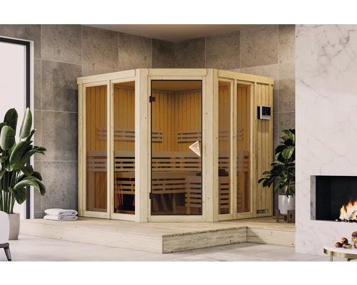 Elementsauna Karibu Sairi inkl. 9 kW Bio Ofen u.ext.Steuerung mit Dachkranz und bronzierter Ganzglastür Ecksauna mit Holzbänken und Glastür in einem hellen Raum