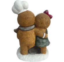 Dekorative Lebkuchenfiguren umarmen sich, ein Bäcker mit Kochmütze und ein Mädchen mit Schleife