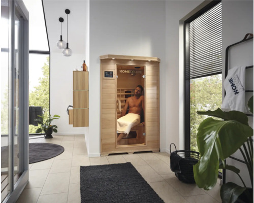 Infrarotkabine Home Deluxe Redsun M 110x105x190 cm Heller Raum mit Infrarotkabine, Waschbeckenunterschrank und Dekorationen.