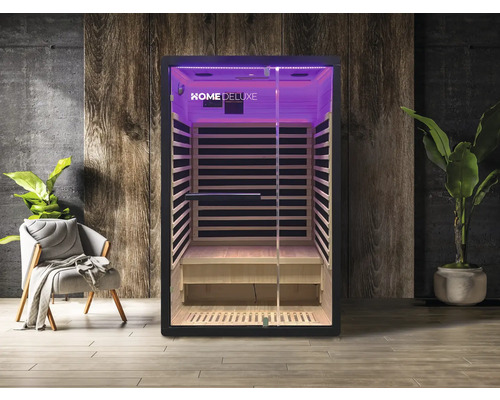 Innenansicht einer Infrarotsauna mit Glasfront und Holzverkleidung, beleuchtet mit violettem Licht.