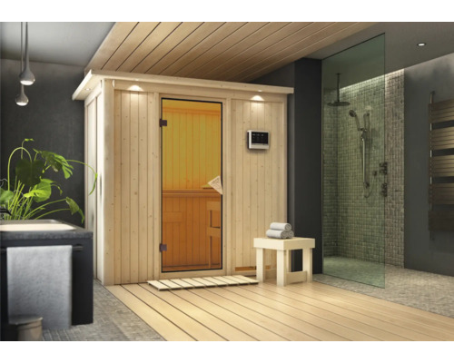 Moderne Sauna mit Glastür und digitalem Bedienfeld in einem Badezimmer mit Dusche.