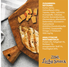 Zusammensetzung und Analyse von Zoë Licky Snack auf Holzbrett mit Kürbis und Hühnerfleisch