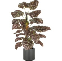 Künstliche Zimmerpflanze im Topf mit gemusterten Blättern.