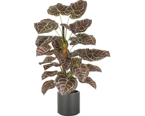 Künstliche Zimmerpflanze im Topf mit gemusterten Blättern.