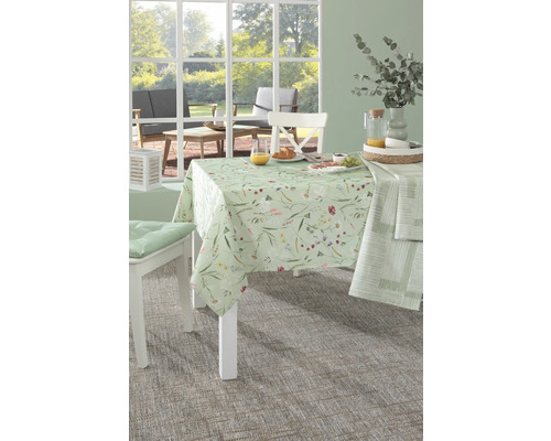 Esstisch mit blumengemusterter Tischdecke und Speisen