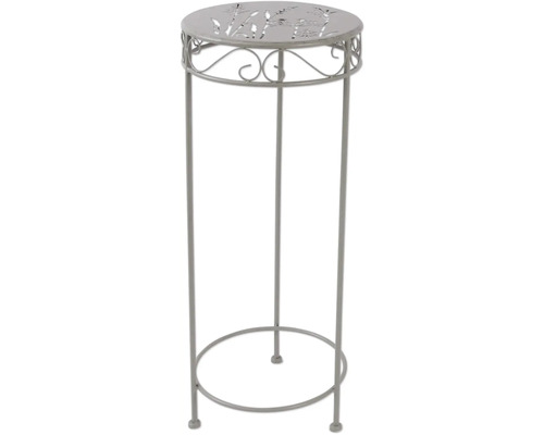 Dekosäule aus Metall mit Pflanzenmuster auf der Tischplatte