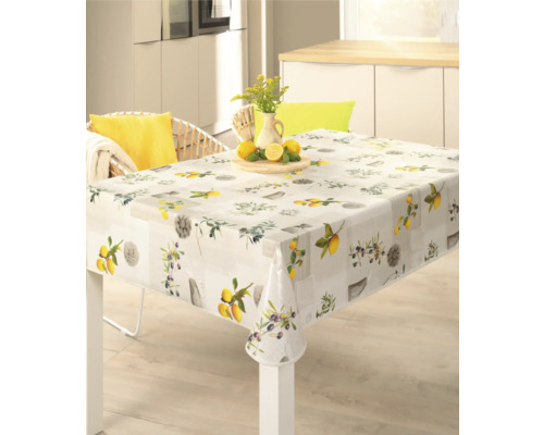 Quadratische Tischdecke mit Zitronen- und Olivenmuster auf einem Esstisch.