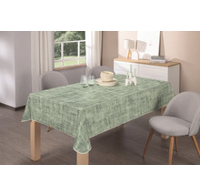 Esstisch mit abstrakter Tischdecke, Geschirr und Dekoration in einem hellen Raum.