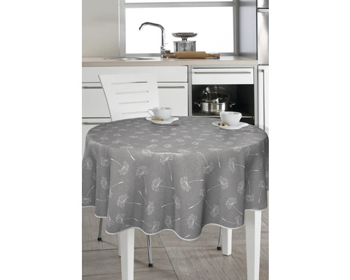 Runder Tisch mit grauer Tischdecke und Pusteblumenmuster in einer Küche.