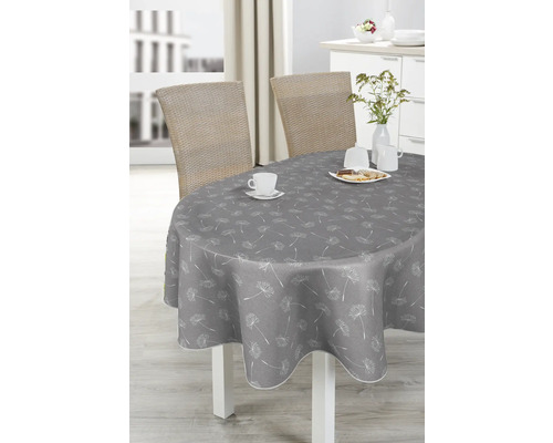 Grauer Tisch mit Pusteblumenmuster, gedeckt mit Geschirr