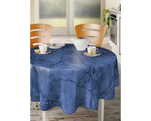Gedeckter runder Tisch mit blau gemusterter Tischdecke