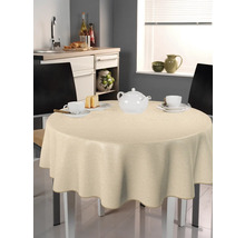 Beigefarbene Tischdecke auf einem runden Tisch in einer Küche mit Geschirr