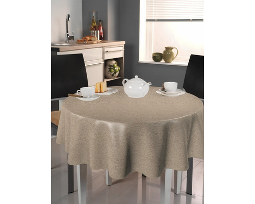 Runder Tisch mit beiger Tischdecke in einer Küche