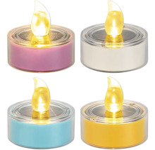 Vier solarbetriebene LED-Teelichter in verschiedenen Farben