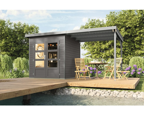 Graues Gartenhaus mit überdachter Terrasse auf einer Holzplattform am Wasser