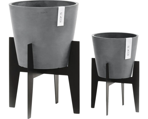 Zwei graue Ecopots Blumenkübel in unterschiedlichen Größen auf schwarzen Pflanzenständern.