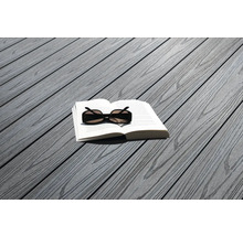 Buch und Sonnenbrille auf grauen Terrassendielen