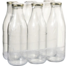 Sechs leere Glasflaschen mit Verschluss in Folie verpackt