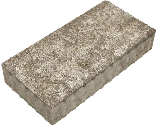Rechteckiger Betonpflasterstein mit rauer Oberfläche und gewellten Seiten.