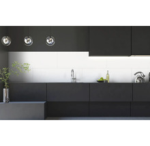 Moderne Küche mit weißen Wandfliesen, dunklen matten Schränken, einer silbernen Armatur und gläsernen Pendelleuchten.