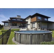 Moderner Garten mit rundem Aufstellpool in Holzoptik, auf einer Rasenfläche neben einem Haus aus Stein mit Terrasse und Gartenmöbeln.