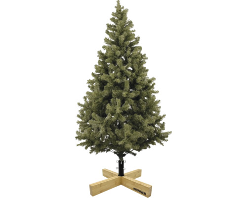 Künstlicher Christbaum mit grünen Nadeln auf einem hölzernen Christbaumständer von Krinner.