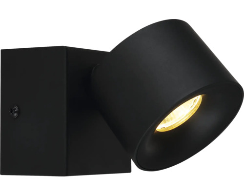 Schwarzer Wandspot aus Metall mit neigbarem zylindrischem Leuchtenkopf und warmem Licht.