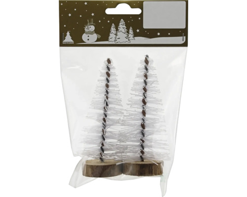 Zwei kleine künstliche Weihnachtsbäume mit weißen Borsten auf runden Holzsockeln in einer Verpackung.